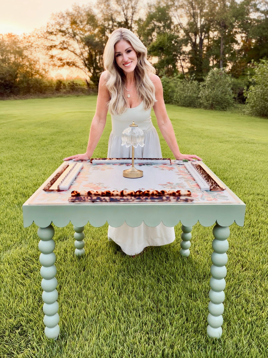 Elyse Pickle, founder of NOLI JUNE, at a scalloped mahjong table